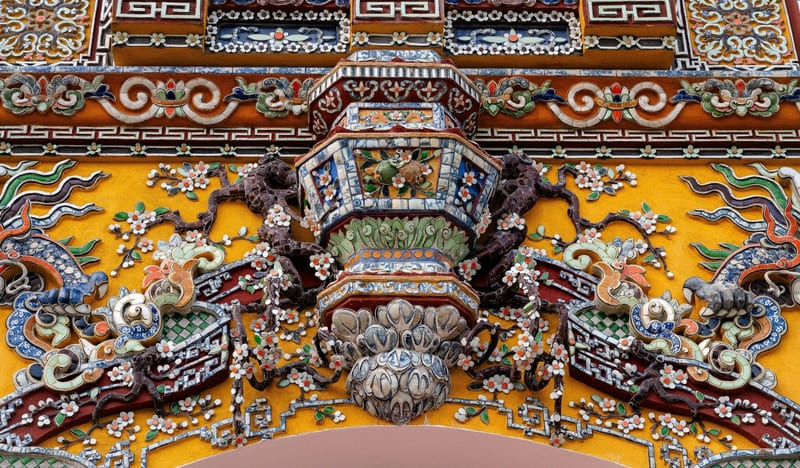 The wall with elaborate carvings in the citadel of Hue