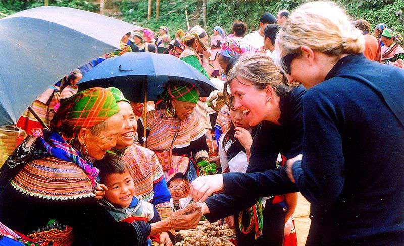 Coc Ly Tuesday Market on the riverside with ethnic traders and boats