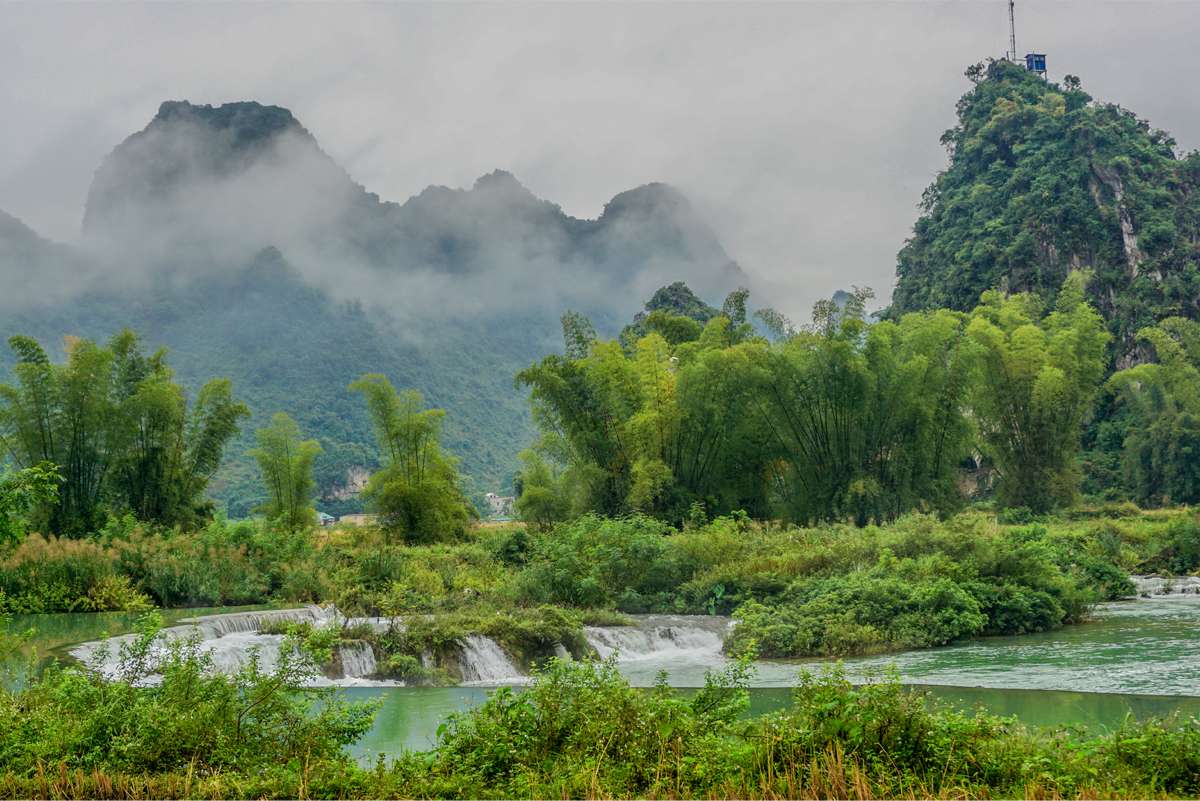 The Quay Son River flows through with clear blue water and majestic waterfalls.