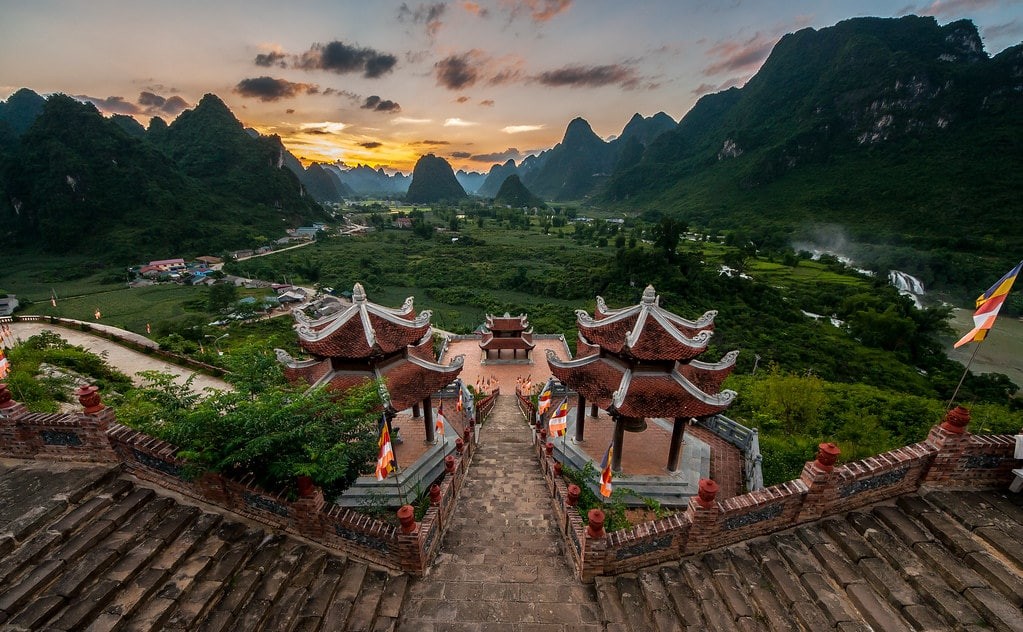 Truc Lam Pagoda with the stunning Ban Gioc Waterfall in the background, facing the Detian Waterfall in China.