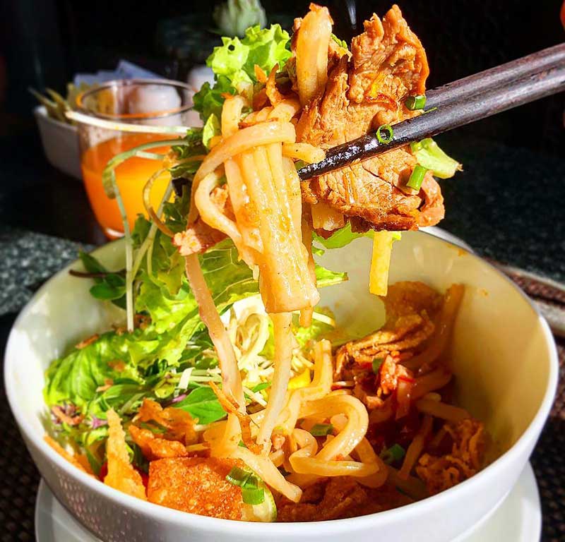 a bowl of cao lau