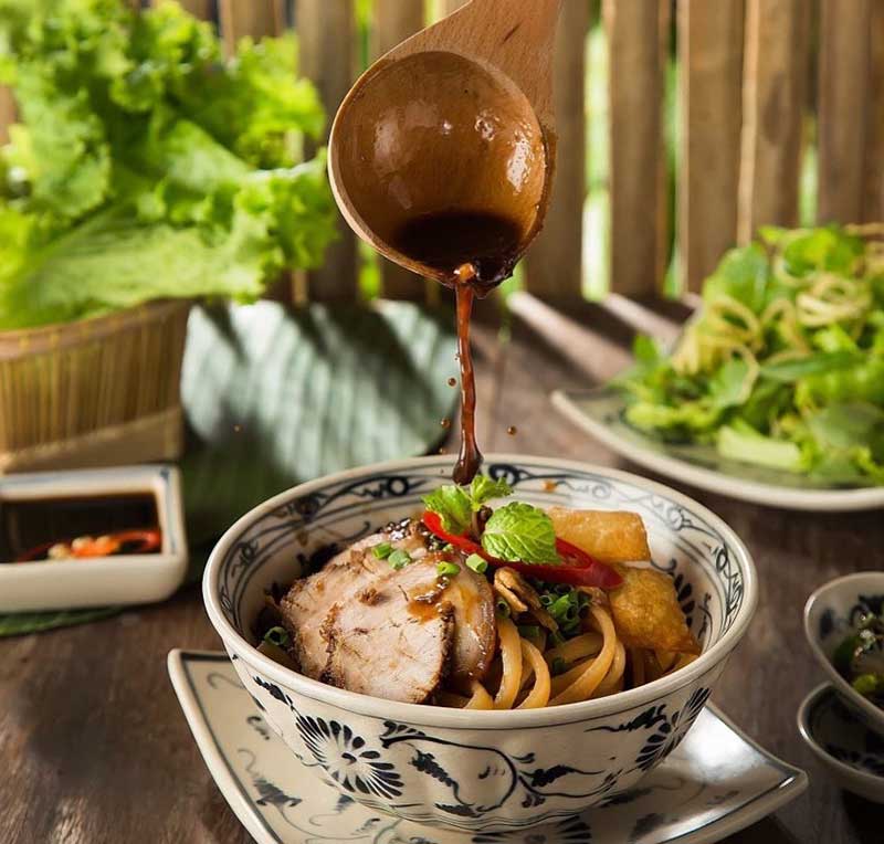 Cao lau is served with two or three spoonfuls of "char siu" sauce