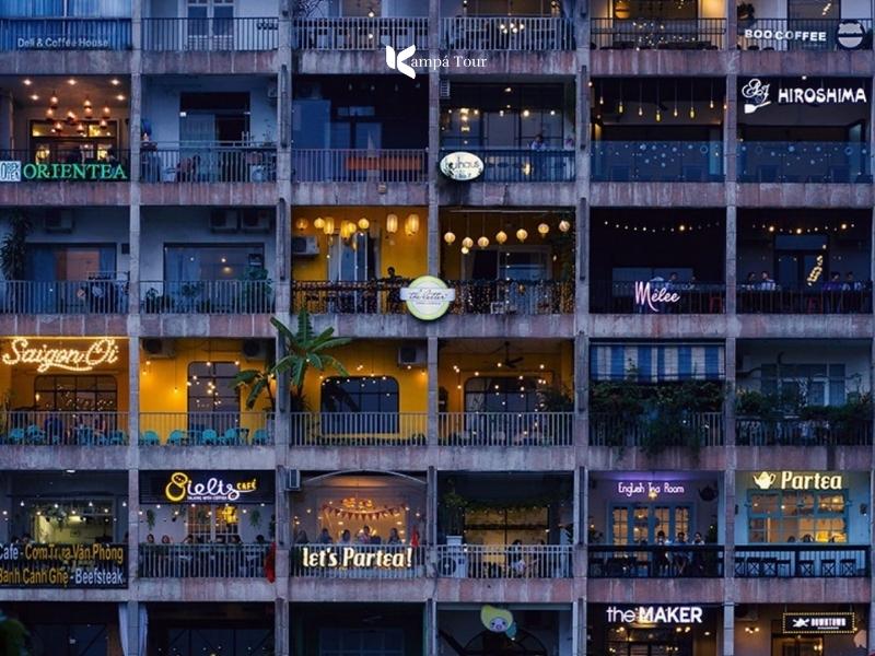 Old 1960s apartment block on Nguyen Hue walking street with a cafe on every floor
