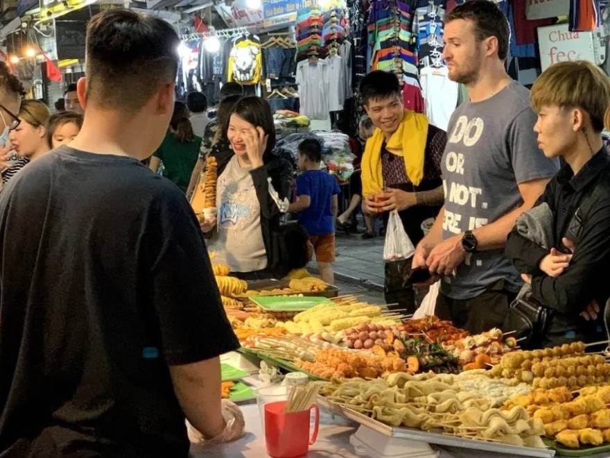 Vibrant stalls and street food vendors at the Hanoi Old Quarter Night Market, stretching from Hang Dao to Dong Xuan Market.