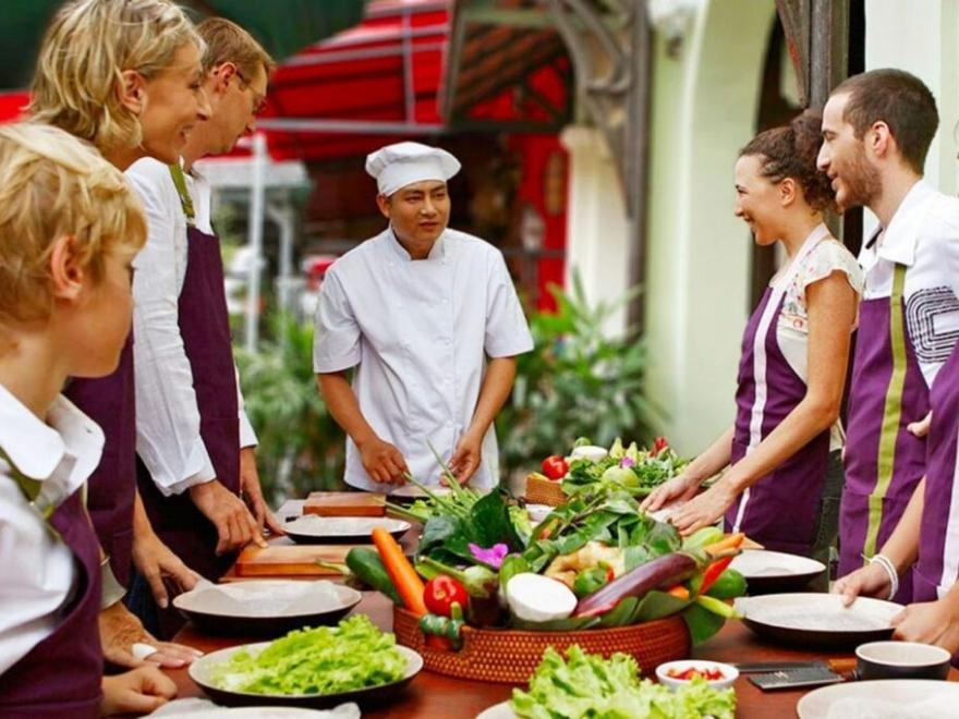 A hands-on Vietnamese cooking class where tourists learn to prepare iconic dishes like Bun Cha or Pho.