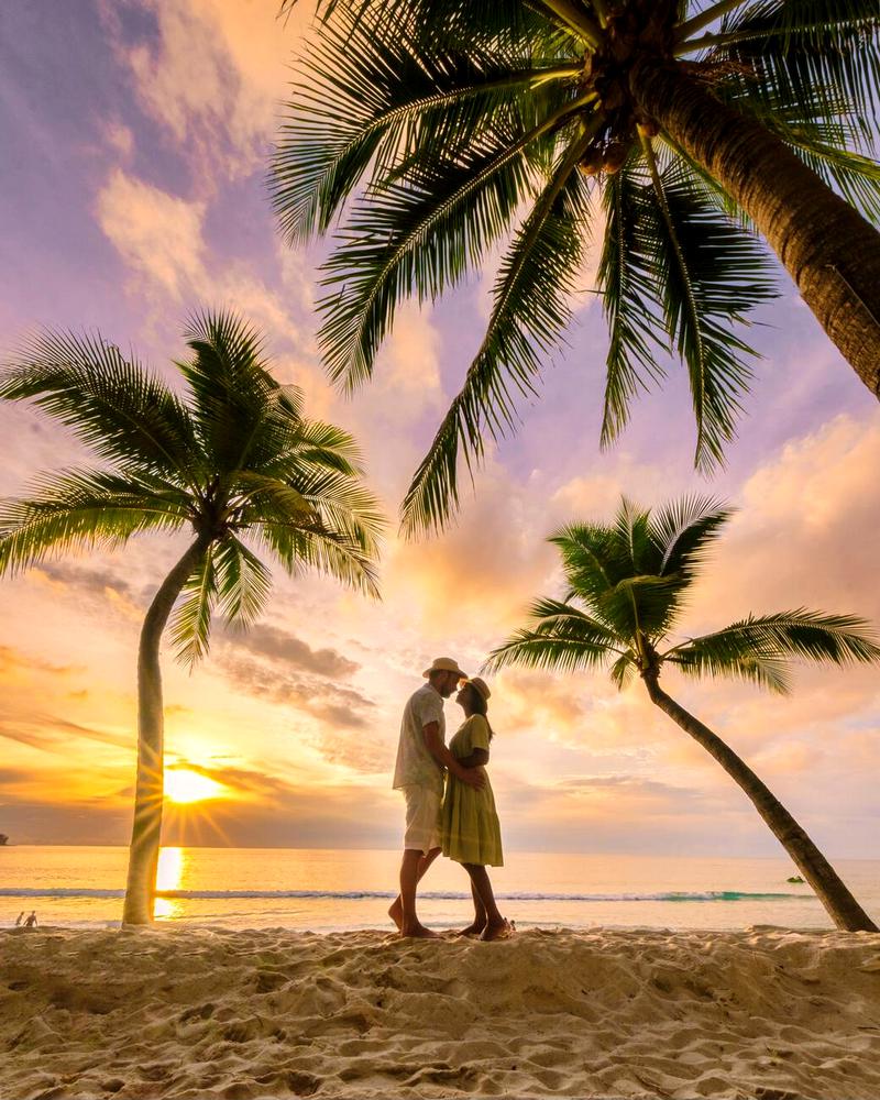 Romance at dusk: Couple on Bang Tao beach in Phuket.