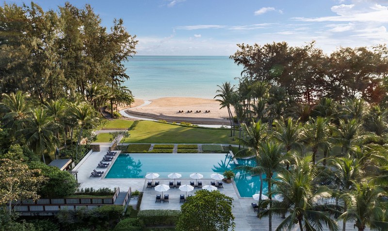 Swimming Pool with a View of Dusit Thani Beach, Surrounded by Trees