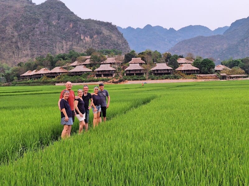 Our dear travelers in Mai Chau. From a distance, these are the traditional stilt houses of the Thai ethnic groups