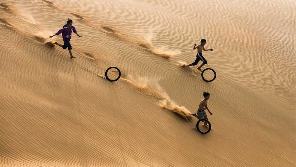 Children having fun on the sand dunes