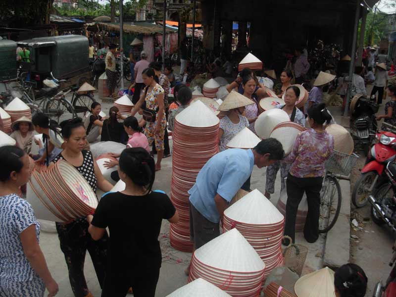 The conical hat market of the artisan village of Chuong, in the north of the country