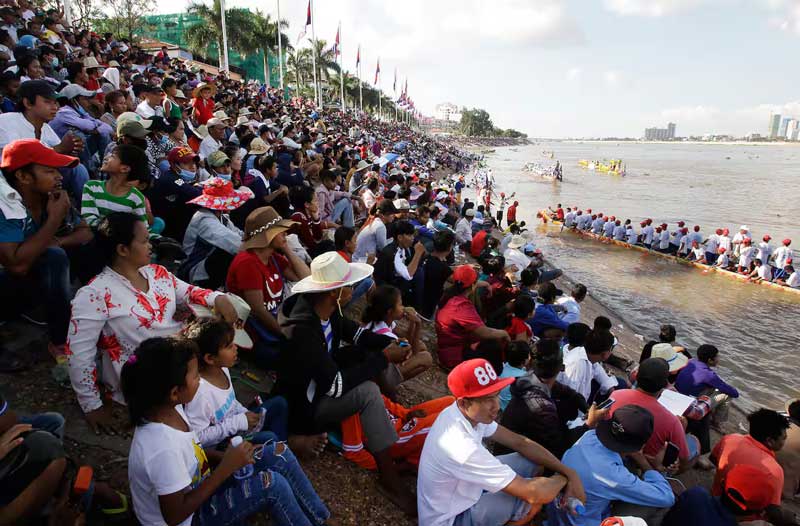 people gather in the river as bon om touk happen