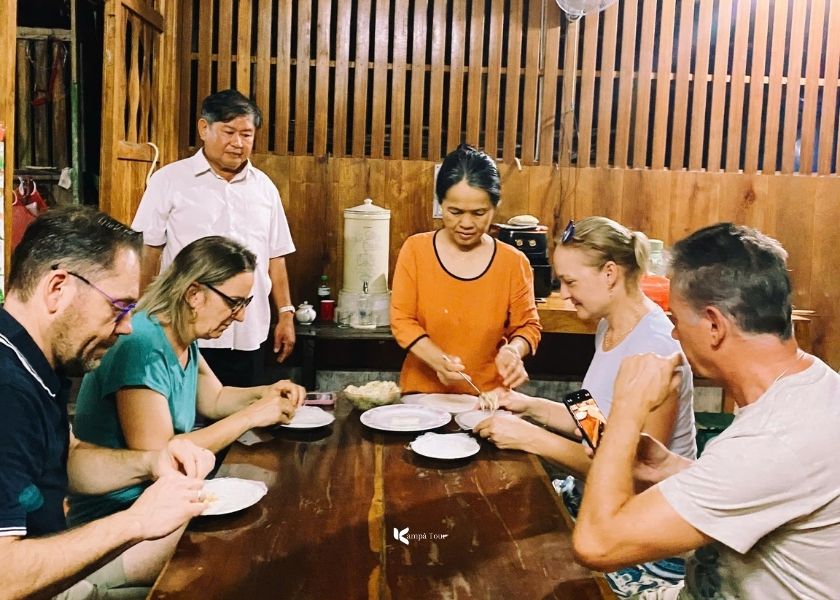 The guests are learning to cook Vietnamese dishes, taught by the homestay owner