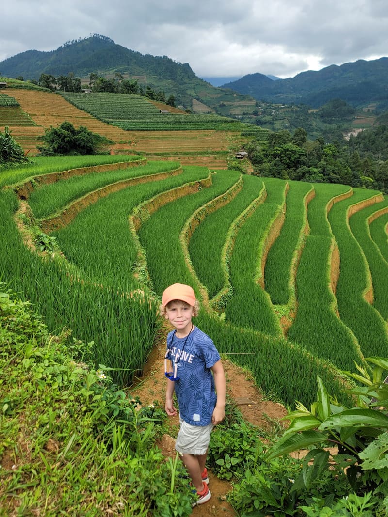 Our little traveller in front of the spectacular rice terraces in July 2024