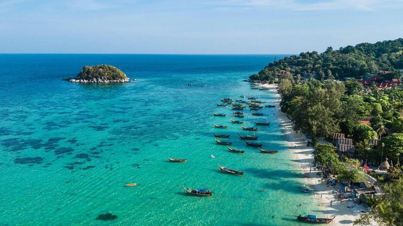 Morning at Koh Lipe beach: aerial view with traditional boat