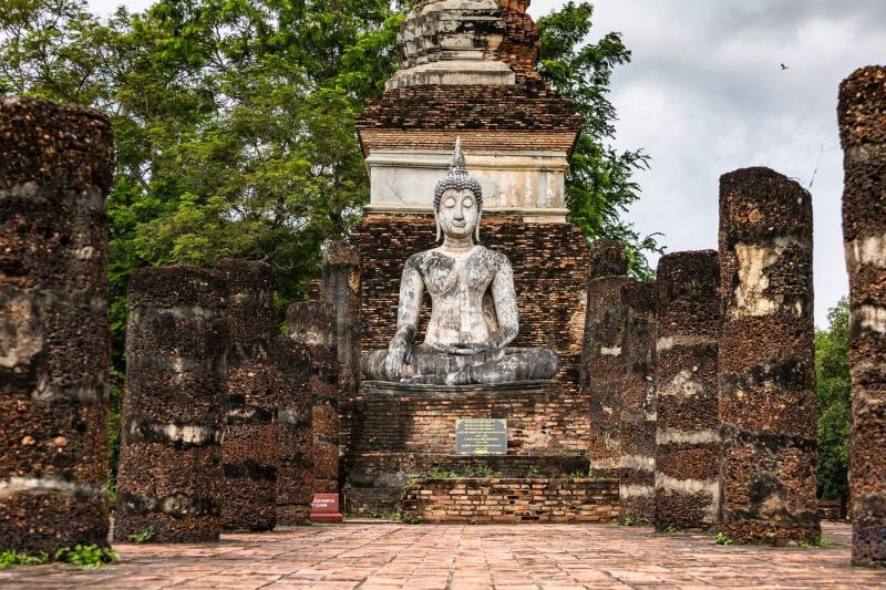 Ancient Buddha statue in the ruins of the chapel of Wat Traphang Ngoen