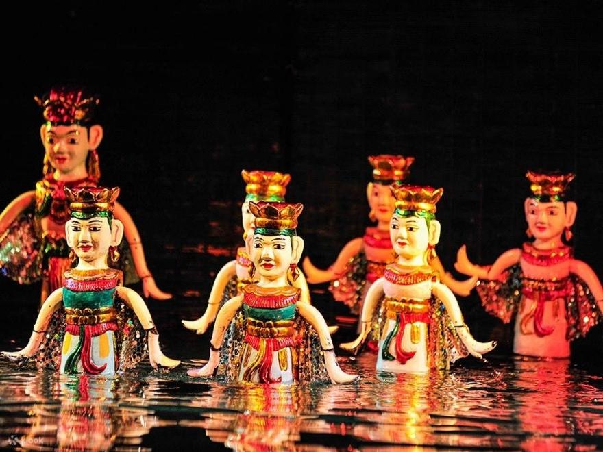 A traditional Vietnamese water puppet show at Thang Long Theatre, providing a cool indoor cultural experience for travelers in June.