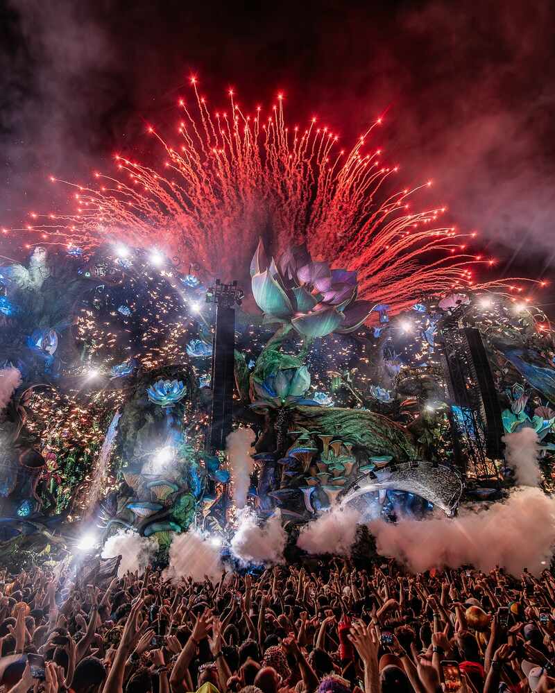 Main stage lit up at an electronic music festival at night