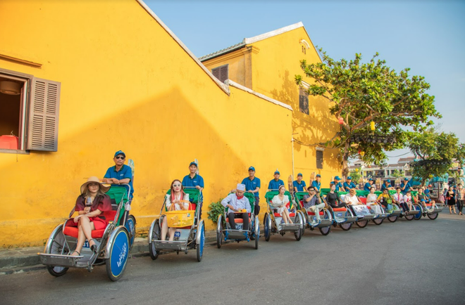 The pedicab moves through the old quarters of Hoi An