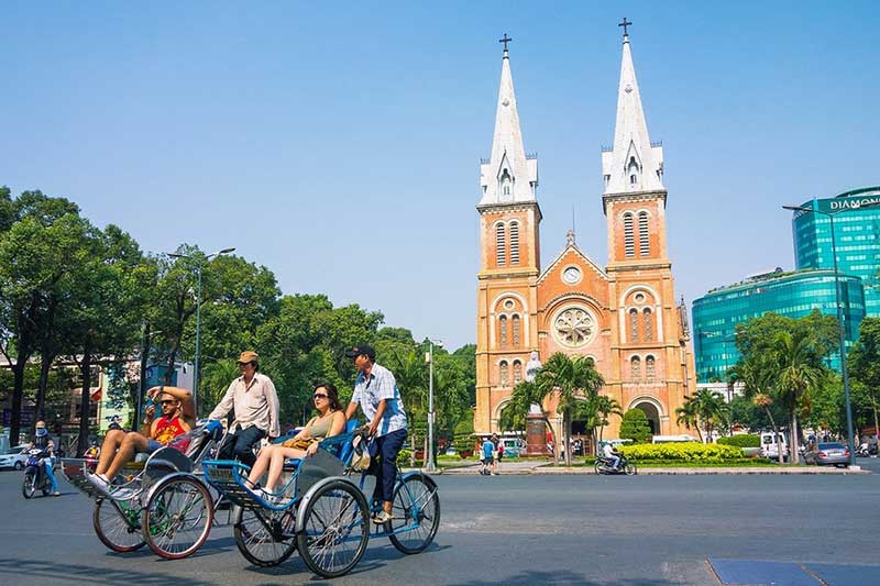 The pedicab moves through the old quarters of Hoi An