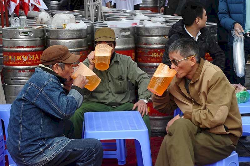 Local people sat on plastic stools and drank beer from tall glasses.