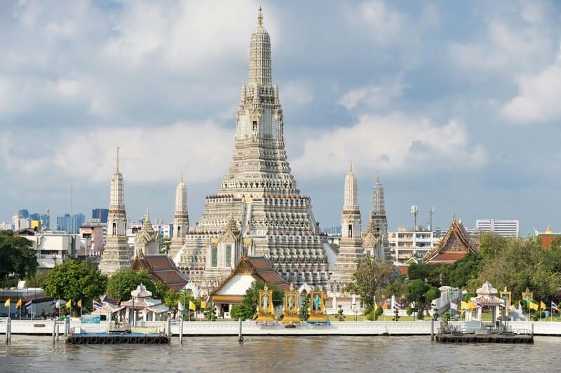 Wat Arun, or Temple of Dawn, stands majestically on the banks of the Chao Phraya River in Bangkok.