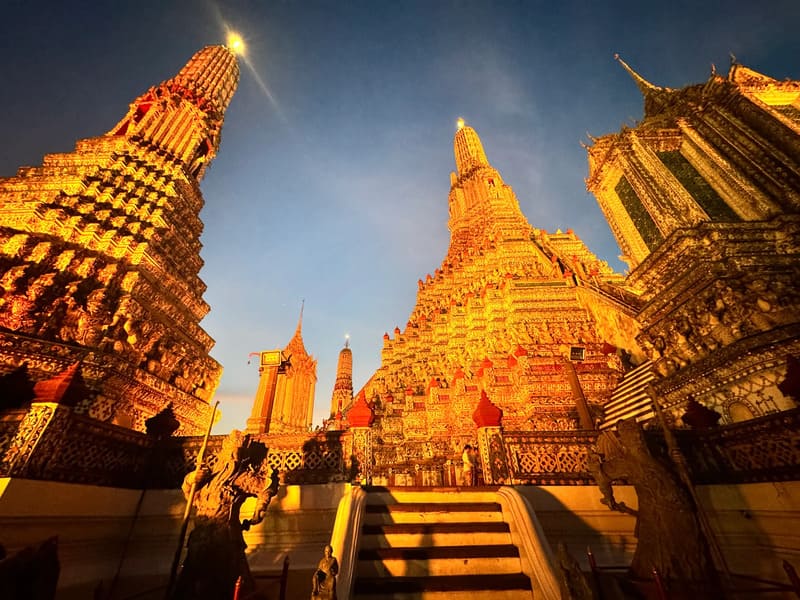 The illuminated Temple of Dawn stands out against Bangkok's night sky
