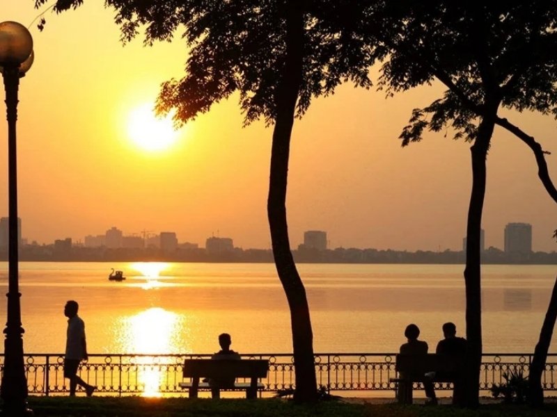 West Lake sunset in Hanoi in October with calm water and autumn sky