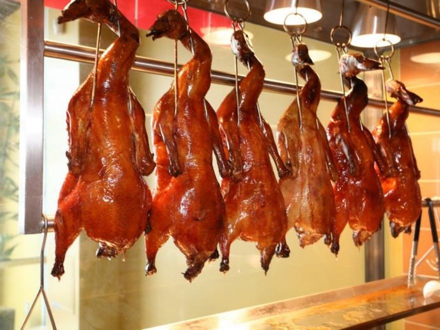 The ducks are roasted evenly, turning a golden brown and emitting a slightly smoky, fragrant aroma.