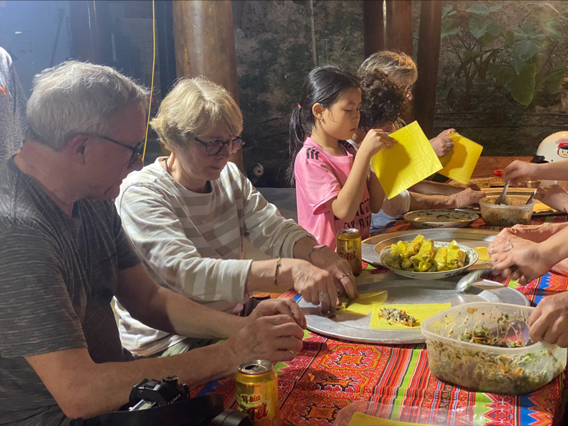 Veronica's family learning how to make Cha Nem - a traditional dish of Vietnam with local host