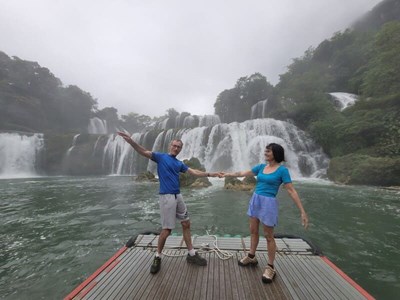 Nature's embrace: Mr. Patrick and Mrs. Marie share a dance on the water, framed by the majestic cascades of Pu Luong.