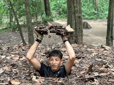 Experiencing the thrill of the Cu Chi Tunnels, a historic site with a rich background.