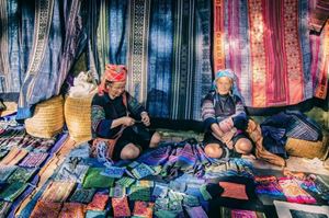 Ethnic women with colorful fabrics in Vietnam
