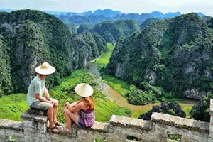 Find peace and beauty at Tam Coc, where lush green landscapes meet tranquil waterways. 