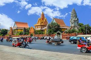 Tuk-tuks and motorbikes create a vibrant urban scene